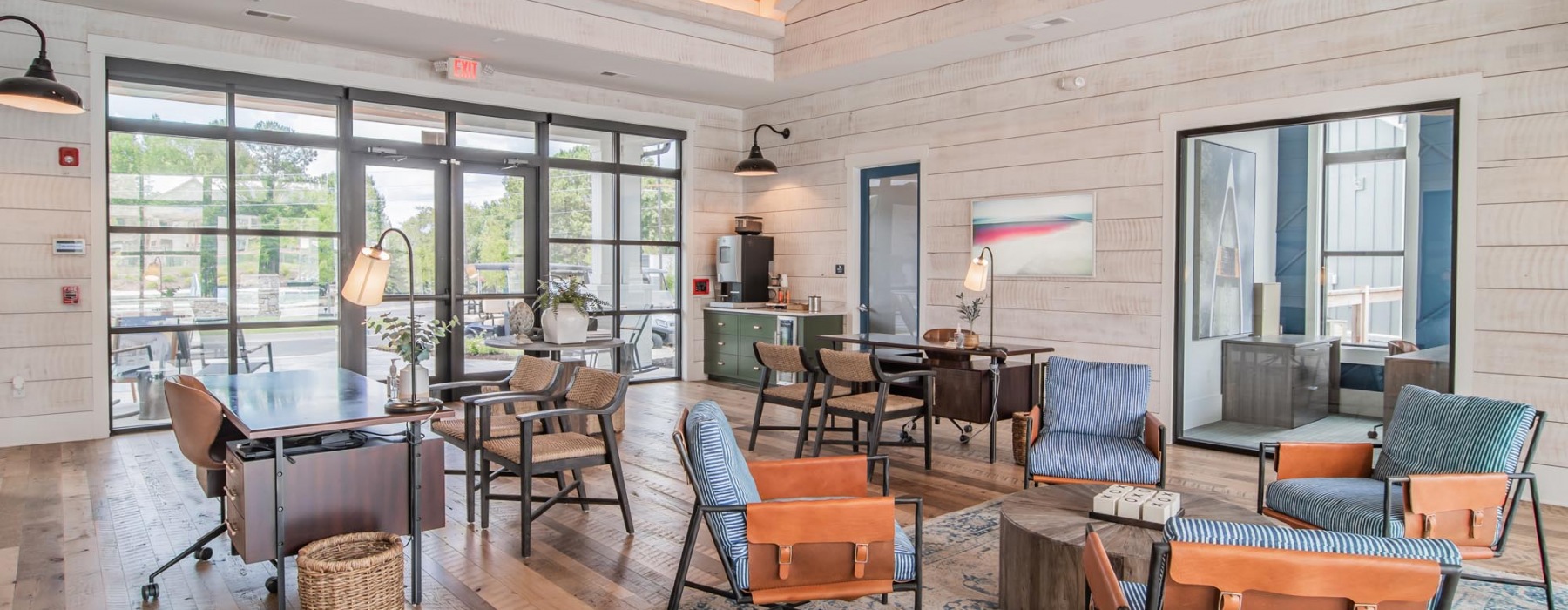 Clubhouse interior with large glass door and window along with seating areas