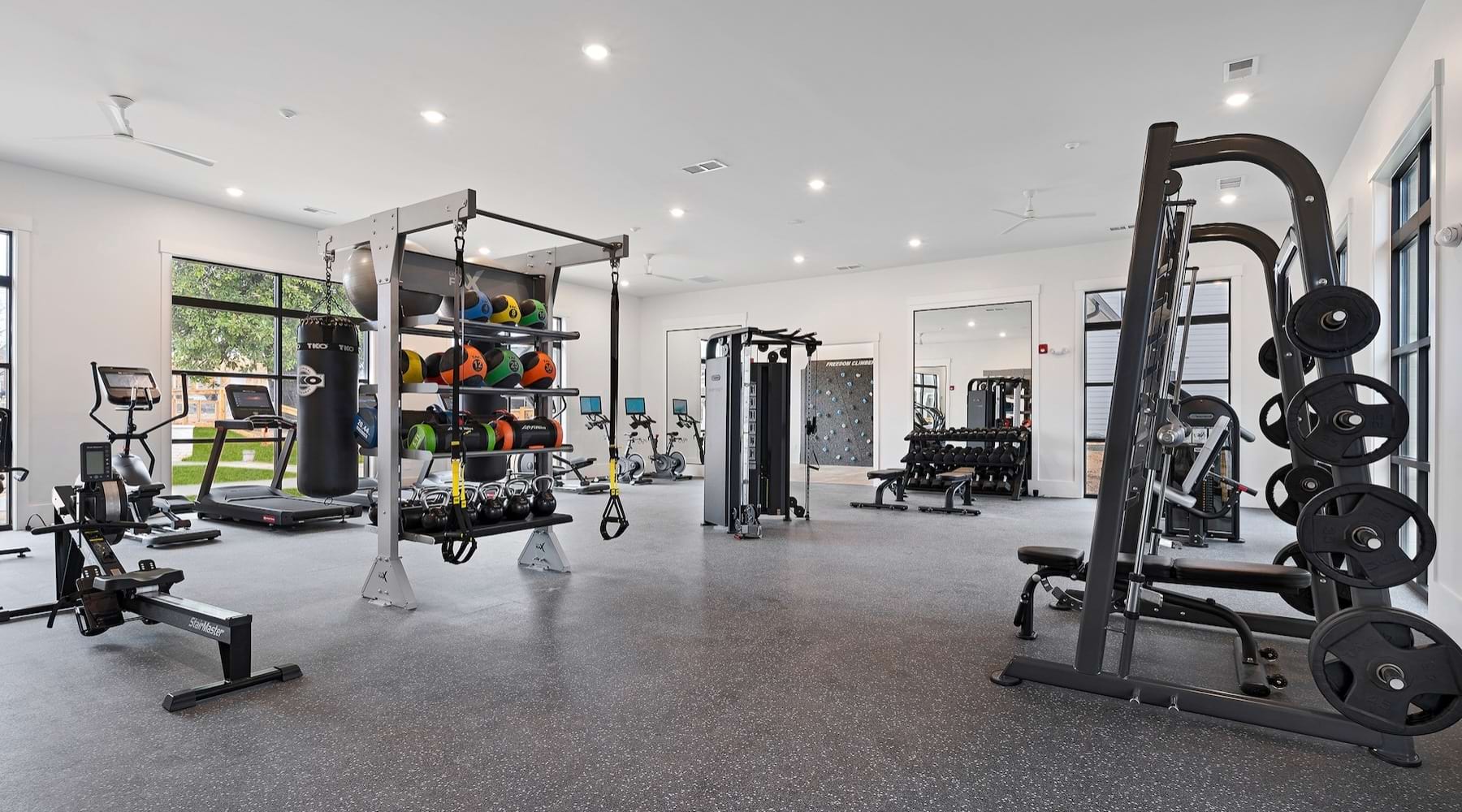 Large fitness center with cardio and weight lifting equipment.