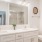 Primary bathroom with white cabinets and double vanity